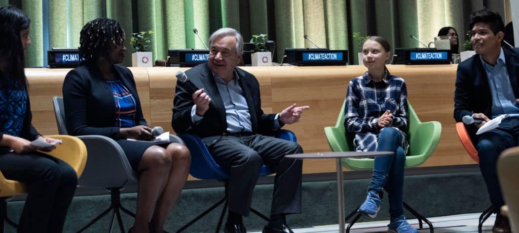 UN Secretary-General, Antonio Guterres, Greta Thunberg, and three others sitting on chairs